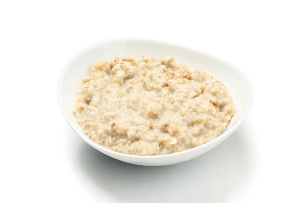 istock Plate with cooked oatmeal isolated on white background 1222918452