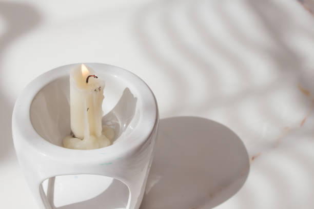 Candle light shining in the dark against wood background. Power outage, blackout concept.