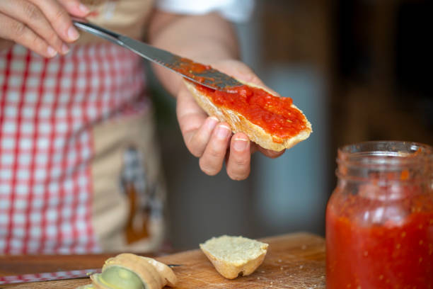 istock spreading homemade tomato sauce on toast 1222920445