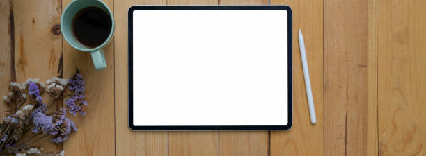istock Top view of modern rustic workspace with blank screen tablet, coffee cup and dry flowers and copy space 1222920610
