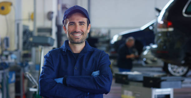 istock Portrait of a young and handsome car mechanic in a car workshop while he is working 1222927708