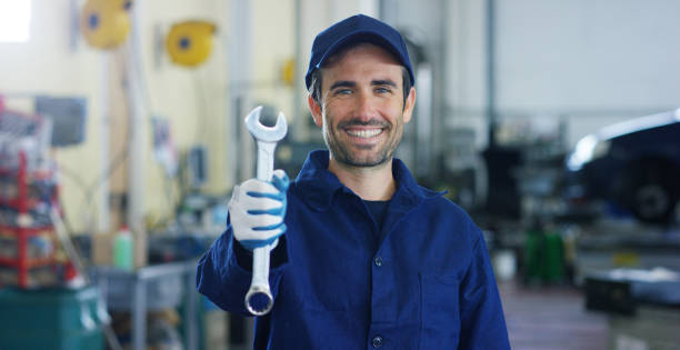 istock Portrait of a young and handsome car mechanic in a car workshop while he is working 1222928126