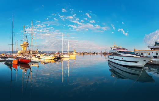 Calm morning at Yacht port Varna, Bulgaria. Sailboat harbor, many beautiful moored sail yachts in the sea.