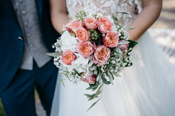 istock Bride holding a wedding bouquet with roses 1222929092