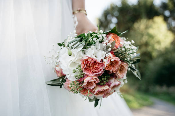 istock Bride holding a wedding bouquet with roses 1222929204