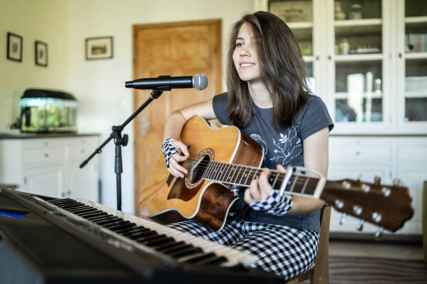 istock Playing the guitar, piano and singing at home 1222930768