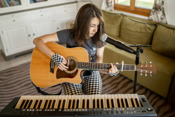 istock Playing the guitar, piano and singing at home 1222930772