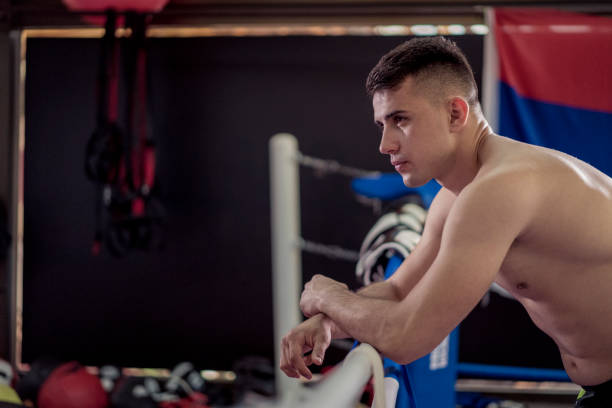 istock Young handsome kick boxer resting after training hard  and preparing for fight. 1222931785