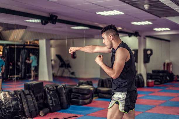 istock Young handsome kick boxer training hard and preparing for fight 1222931853