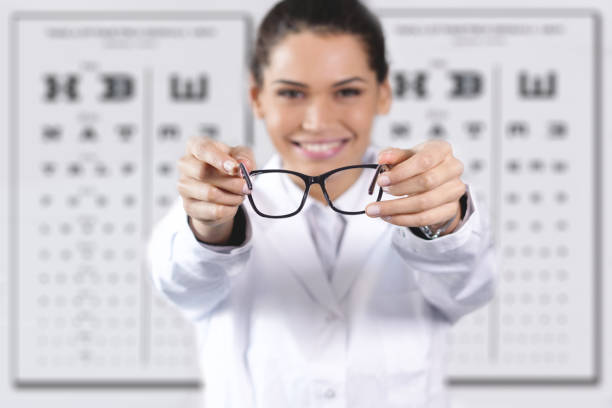 An ophthalmologist doing a visual examination for a customer at an optical center. Concept of: medical examination, assistance, optics and customer care.