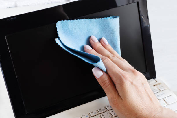 istock Woman hand disinfecting computer screen with antibacterial cloth. 1222933146