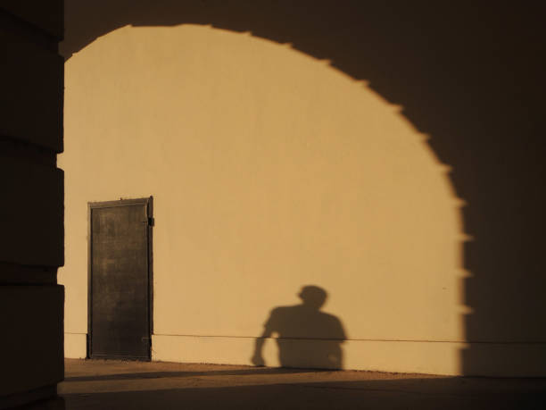 istock Shadow on the wall of the man passing through the passage 1222933215