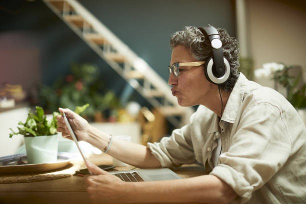 istock One woman blowing a kiss at a videoconference. 1222934171