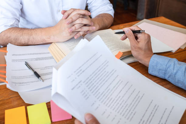 istock Tutor books with friends education, Group students studying and teaching helping and study course with books in library for learning tutoring homework a test or exam 1222935850