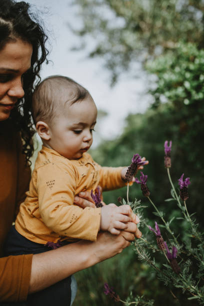 istock Woman With Son Looking At Flowers 1222937277