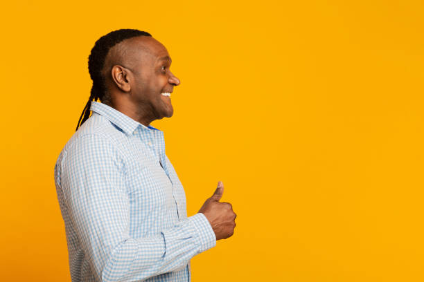 istock Positive middle aged african man gesturing thumb up, looking at copy space 1222937855
