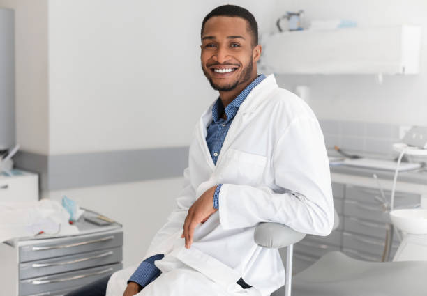 istock Cheerful black man stomatologist resting at workplace 1222938807