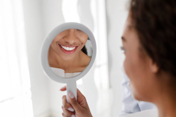 istock White smile in mirror, african girl visiting dentist 1222938833
