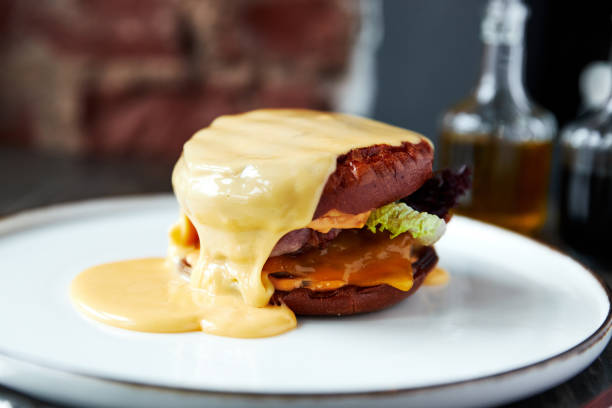 istock cheeseburger, burger with lots of cheese she has a white plate 1222940525