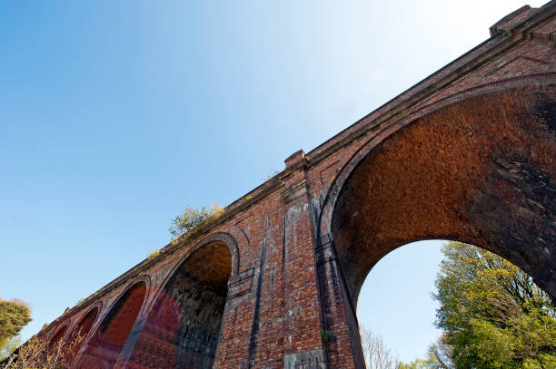 Series of towering high arches straddle the road on this pair of brick built Victorian railway train viaducts, Poole, Dorset, England