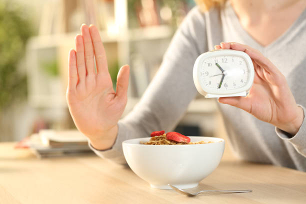 Woman hands on intermittent fasting doing stop sign Woman hands on intermittent fasting doing stop sign fasting stock pictures, royalty-free photos & images