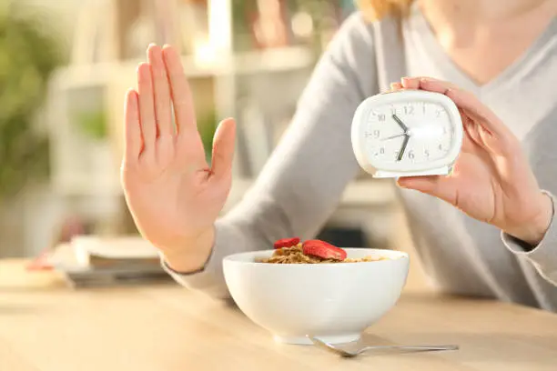Woman hands on intermittent fasting doing stop sign