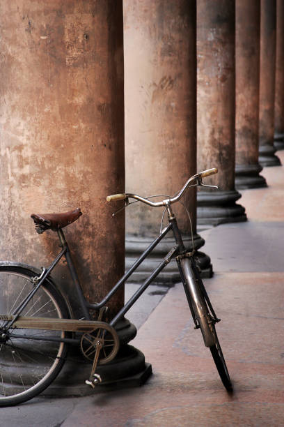 Row of old columns with a very deteriorated and old bicycle parked