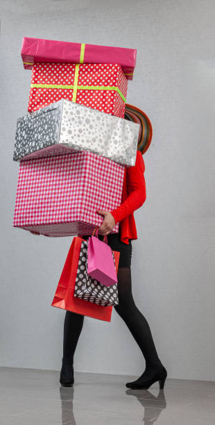 女性ベアリングギフト - christmas stack gift carrying ストックフォトと画像