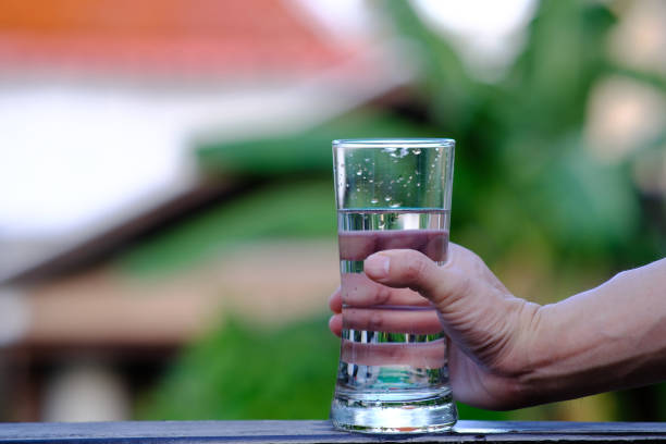 istock Holding a glass of water 1222949509