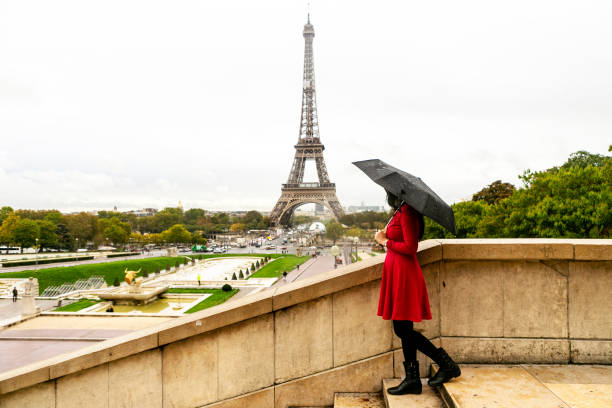 istock asian traveler with umbrella in Paris 1222950355