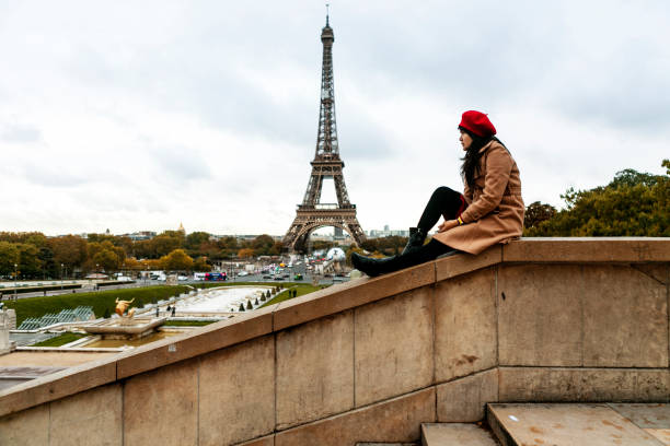 istock asian traveler sitting with Eiffel tower view in Paris 1222950609