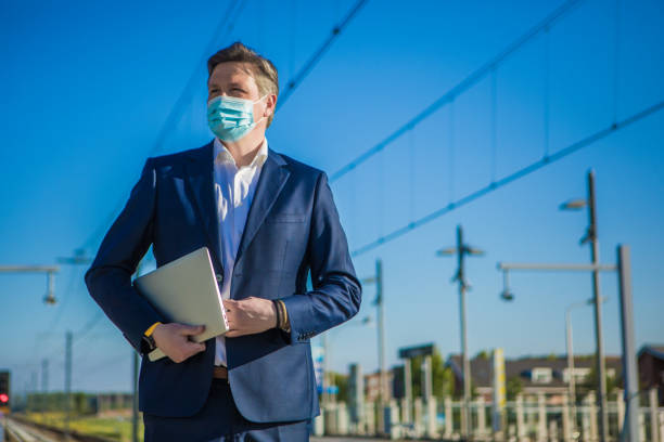 istock A businessman at a european train station during virus outbreak 1222951985
