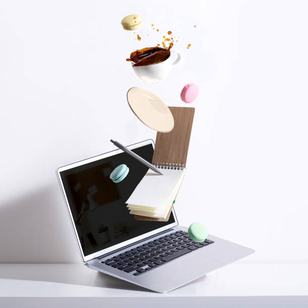 Business art concept with falling laptop and coffee splash. Business art concept with falling laptop and coffee splash. messy vs clean desk stock pictures, royalty-free photos & images
