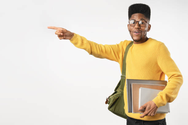 istock College student in eyeglasses with backpack holding laptop while pointing isolated on white background 1222953318