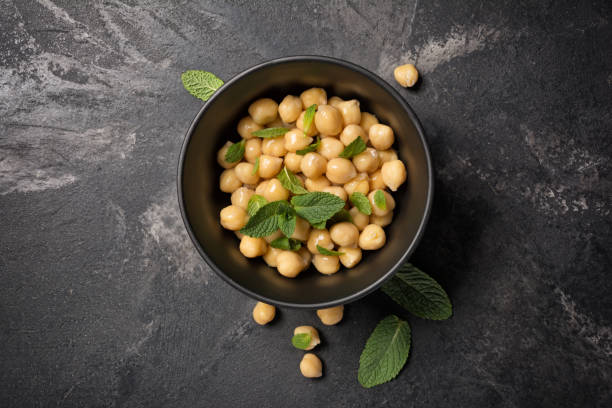 chickpeas in bowl with spice of mint leaves as ingredient for vegetarian meal