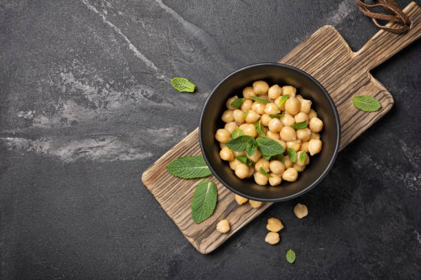 Chickpeas in bowl with spice of mint leaves as ingredient for vegetarian meal