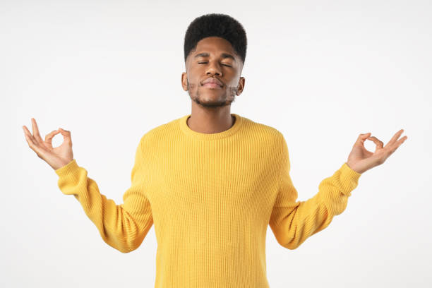 istock Young african man meditating with eyes closed isolated over white background 1222954108