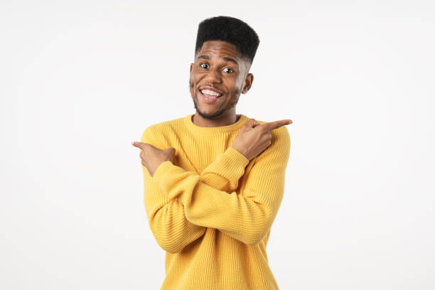 istock Handsome young african man pointing away while standing against white background 1222954152