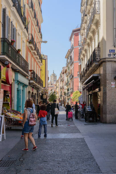 People Strolling Through The Chueca Square And Buying In Their Stores The Cradle Of Gay Pride In Madrid. stock photo