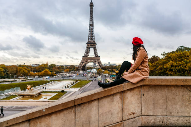 istock asian traveler sitting with Eiffel tower view in Paris 1222954904
