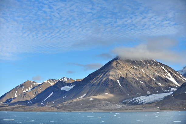 istock Snowy mountains. Reflection in sea water. 1222955621