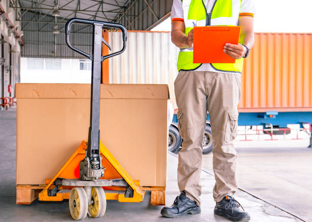 istock Worker courier holding clipboard inspecting control load shipment goods into container truck 1222956633