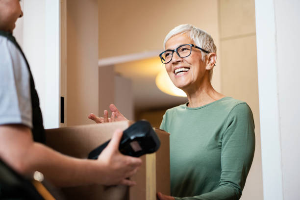 Senior woman received package from courier