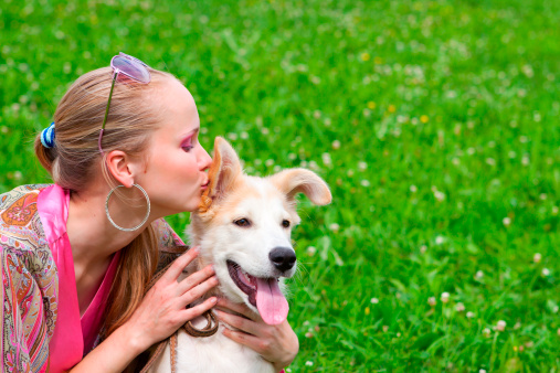 Young girl embracing favorite puppy golden retriever