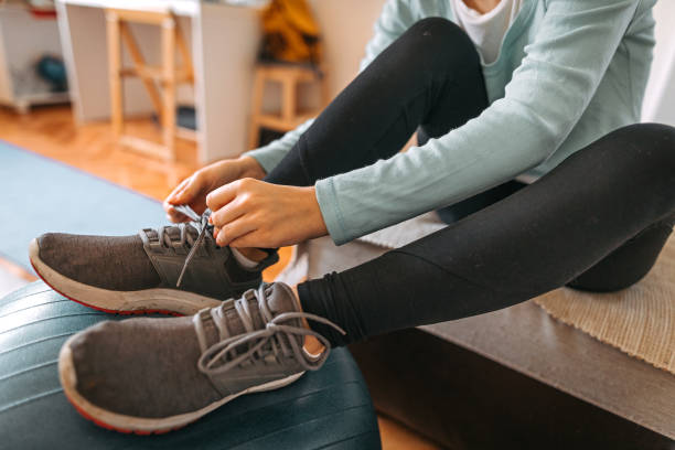 istock Girl tying shoelace for home workout 1222961183