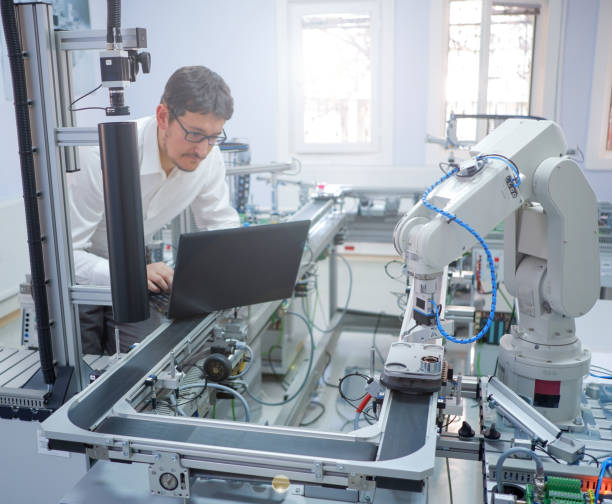 istock Industry 4.0 concept; Engineer is working on laptop to programming smart factory automation 1222962631