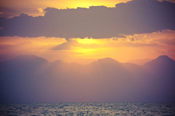 istock sunset over the sea and mountains 1222962993