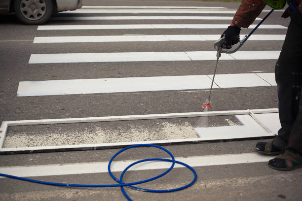 istock two men painting crosswalk zebra 1222963096