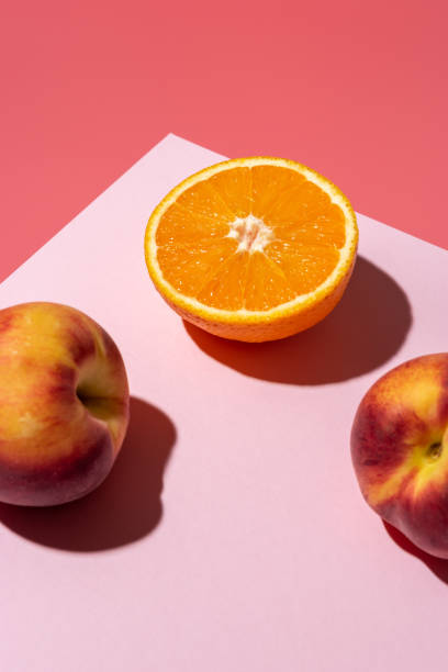 istock Orange fruit with peaches on bright background. Minimal food concept. 1222963268