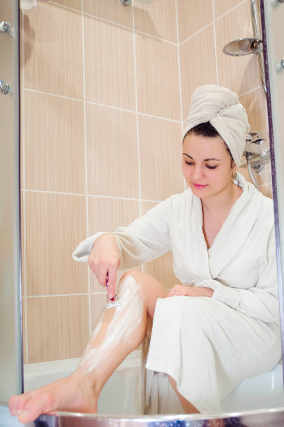 istock Woman shaves her leg 1222964538